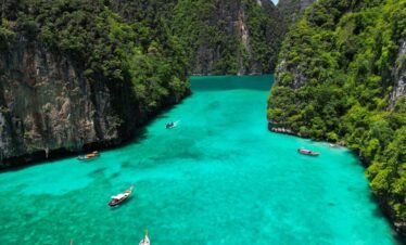 a group of boats floating on top of a body of water